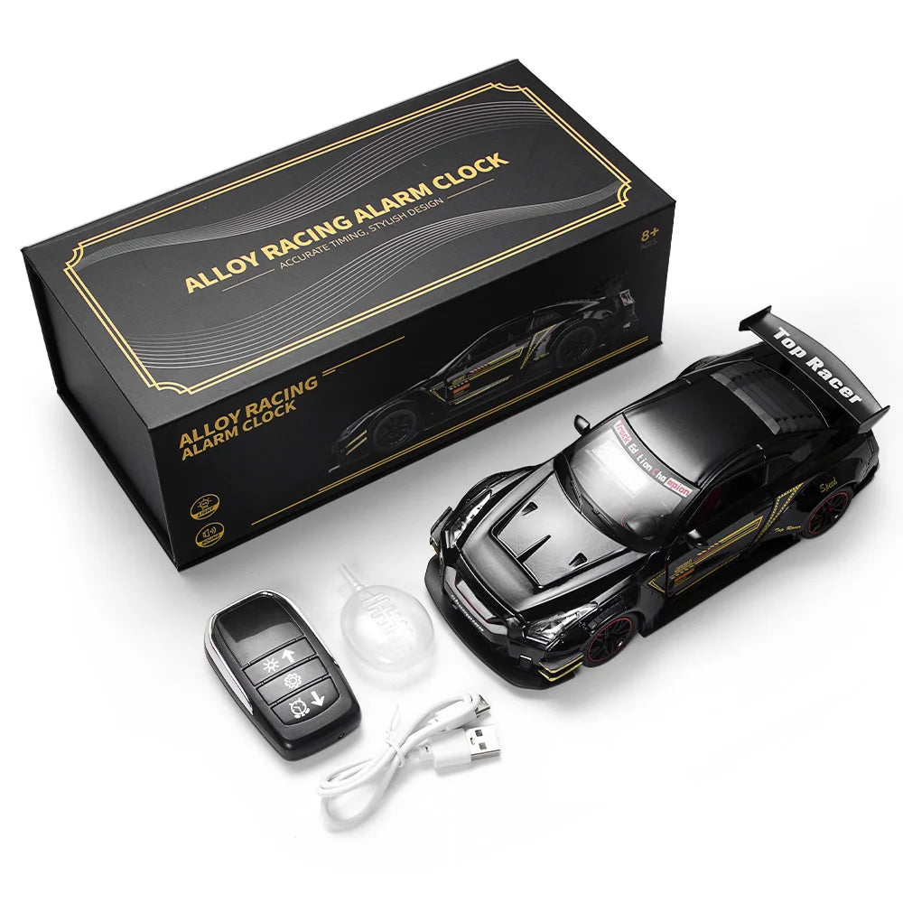 A black die-cast car model is shown next to its packaging and a remote control device.