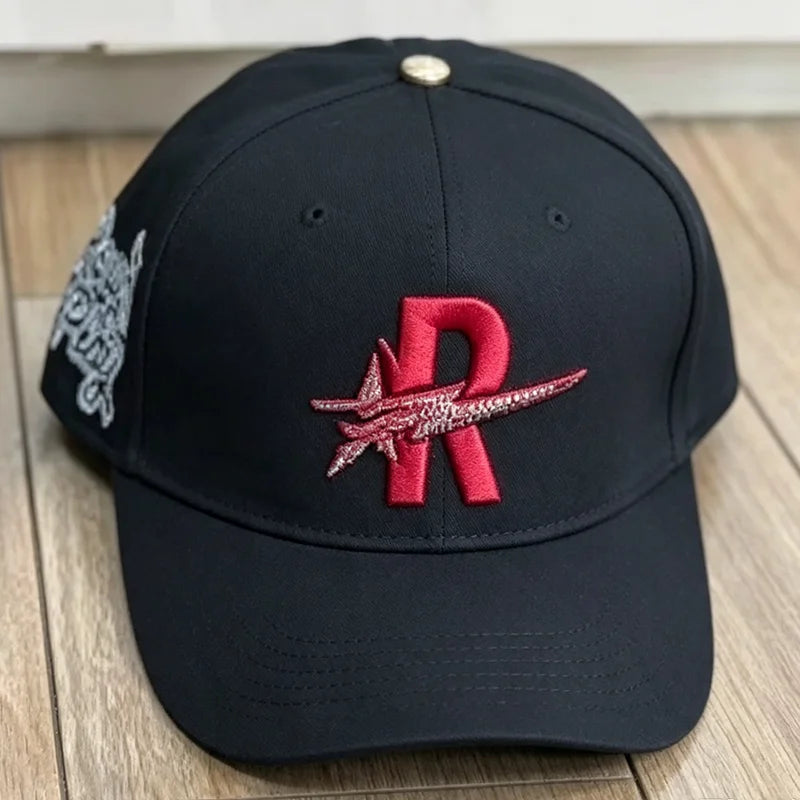 Black baseball cap embroidered with a red star logo
