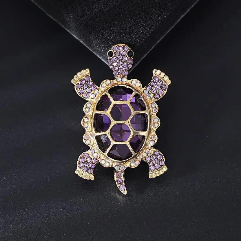 A vintage marine life brooch pin set featuring a purple and gold turtle design.