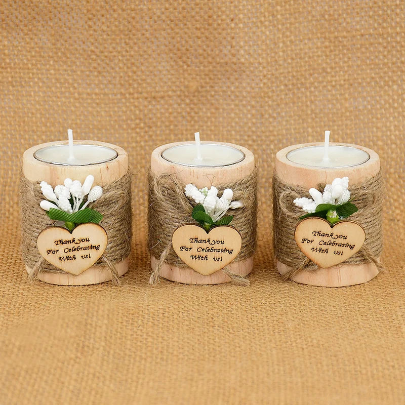 Three wooden tealight candle holders wrapped in twine featuring a thank you message and white flowers.