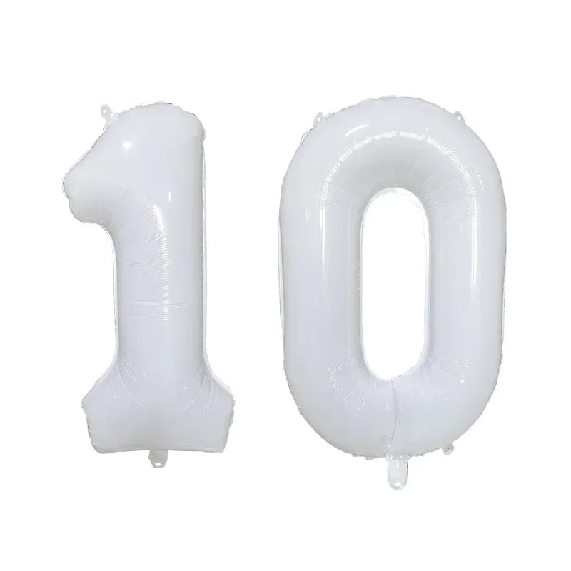 Two white helium foil number balloons, one '1' and one '0', for a birthday party.