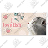 A light gray cat looks toward the viewer with a pink heart and fish icons surrounding the text I love fish