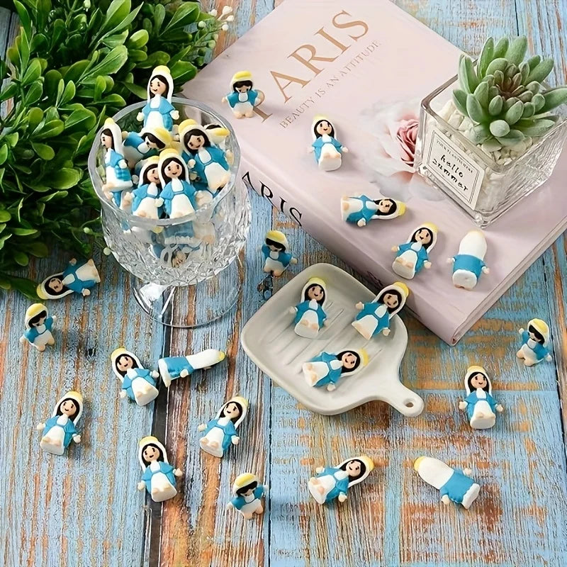 A collection of multicolor mini Virgin Mary statues in various poses displayed on a pink book and glass.