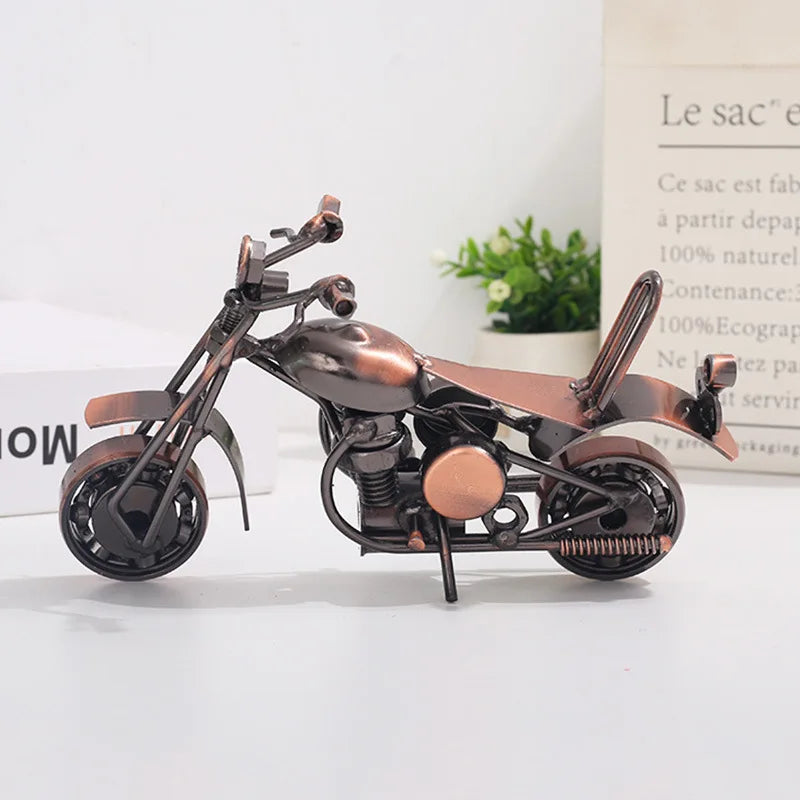 A dark bronze retro iron motorcycle figurine displayed on a white surface.