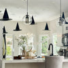 Classic black witch hats with hanging rope used as Halloween décor displayed above a kitchen counter.