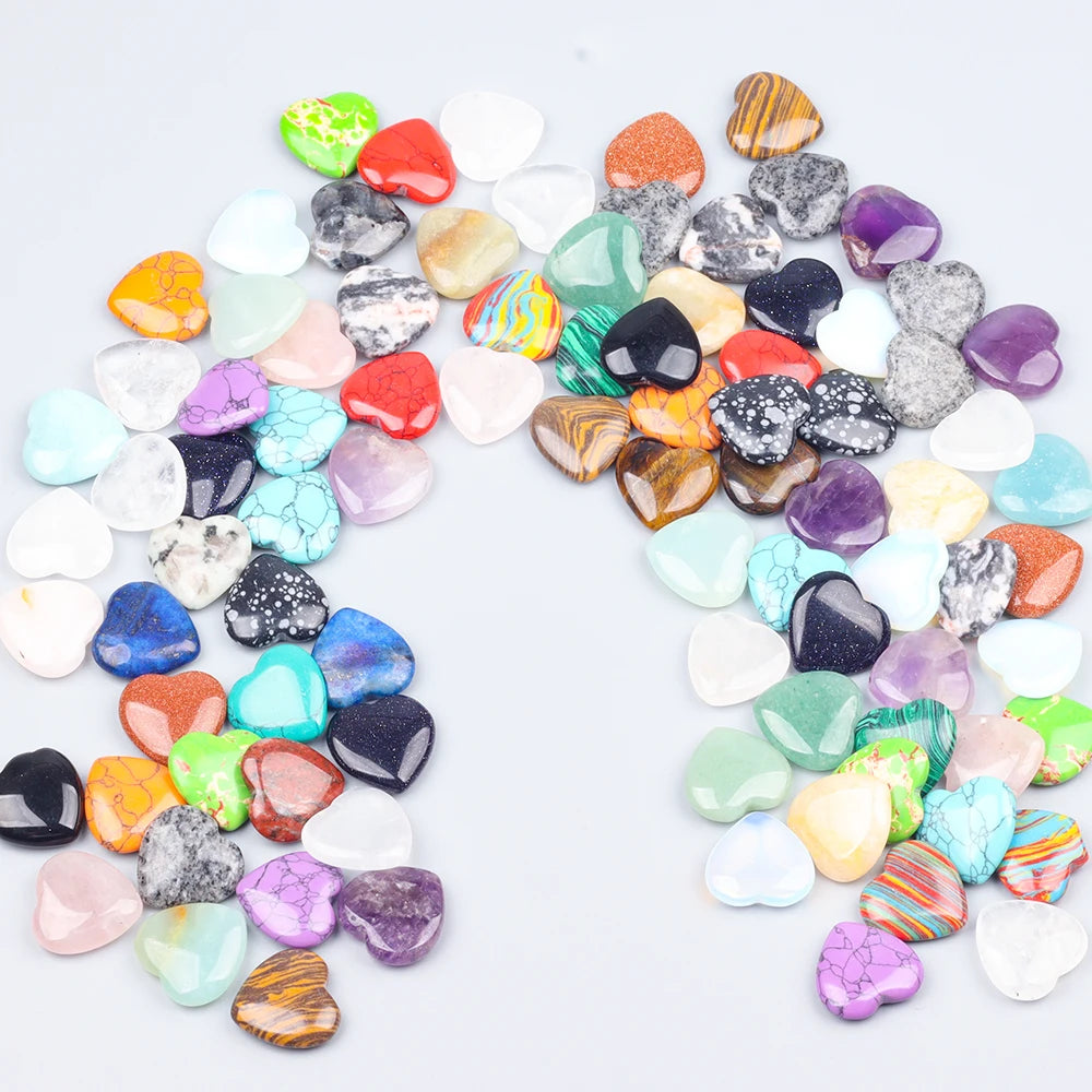 A collection of heart-shaped amethyst crystal stones in various shades of purple, green, and clear quartz.