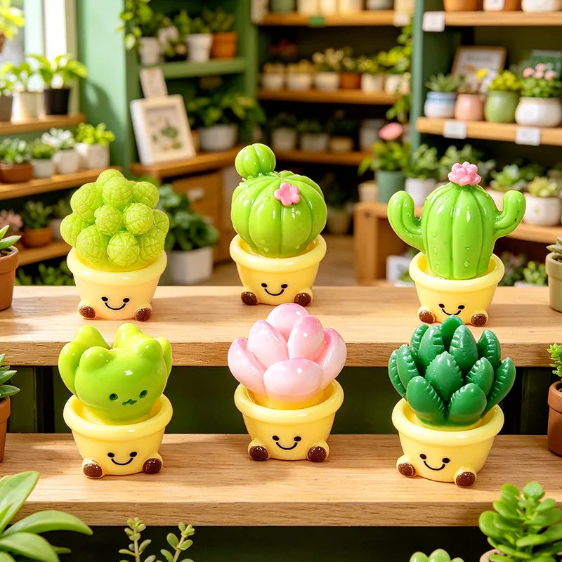 A collection of small, green and pink cactus resin charms in yellow pots displayed on a wooden shelf.