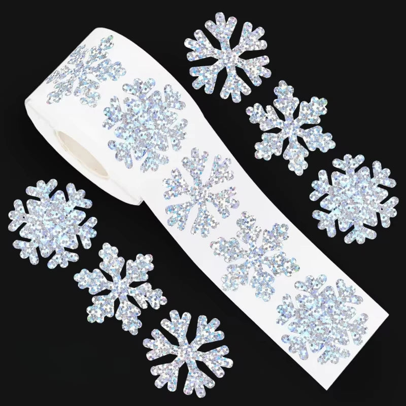 A roll of white sticker paper decorated with blue glitter snowflakes.