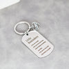 A silver heart-shaped stainless steel keychain with engraved inspirational reminders on a gray background.