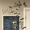 White script wall decor featuring bats and text about hangover recovery