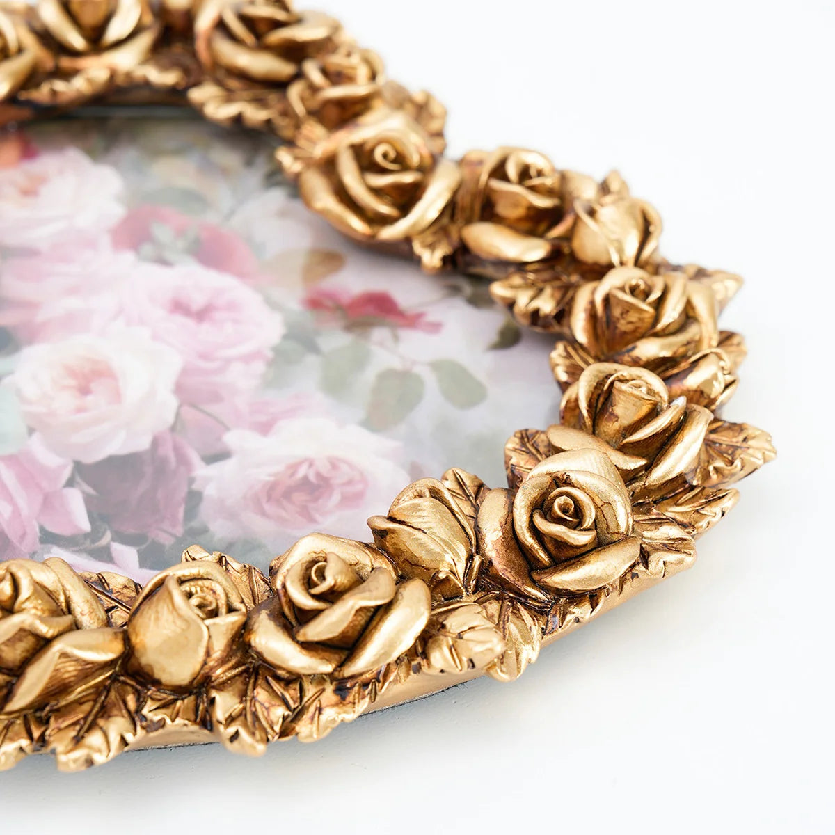 Gold-toned rose heart-shaped resin photo frame with a multi-head floral design