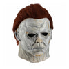 A realistic latex mask of a pale, scarred face with reddish-brown hair and a menacing expression.