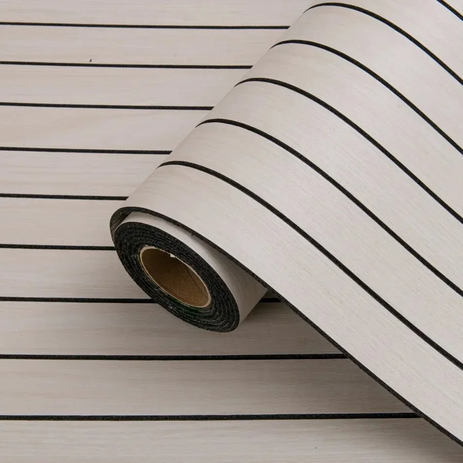 Roll of self-adhesive 3D wood grain wall panels with black stripes laid on a light wooden surface.
