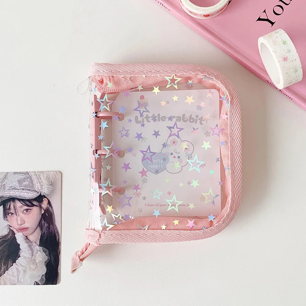 A pink glitter star card binder with a clear window displaying a cute rabbit design and stars.
