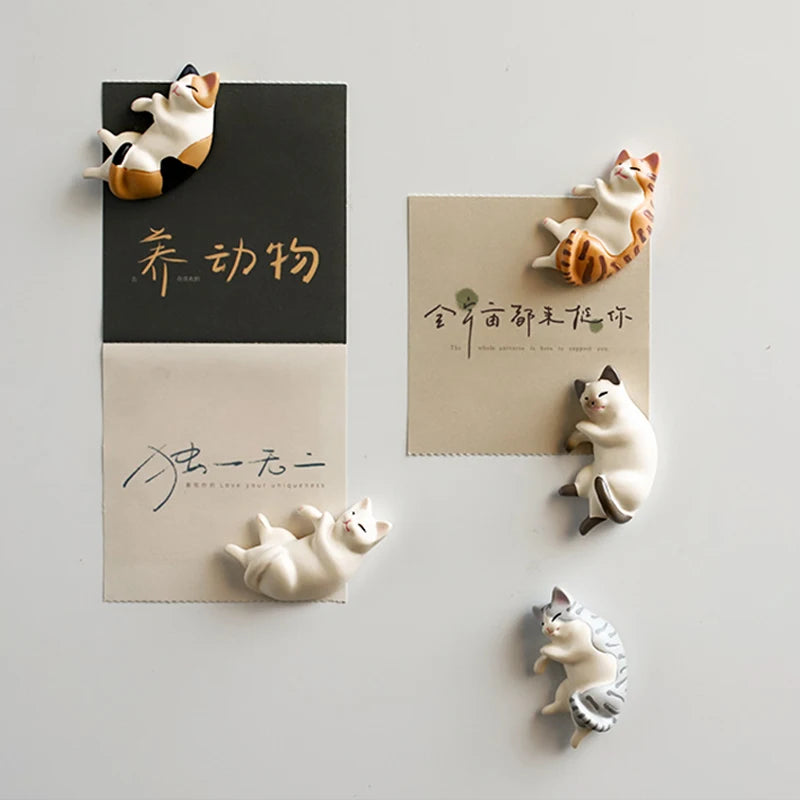 A set of six fridge magnets featuring various designs of lazy cats in different poses and colors.