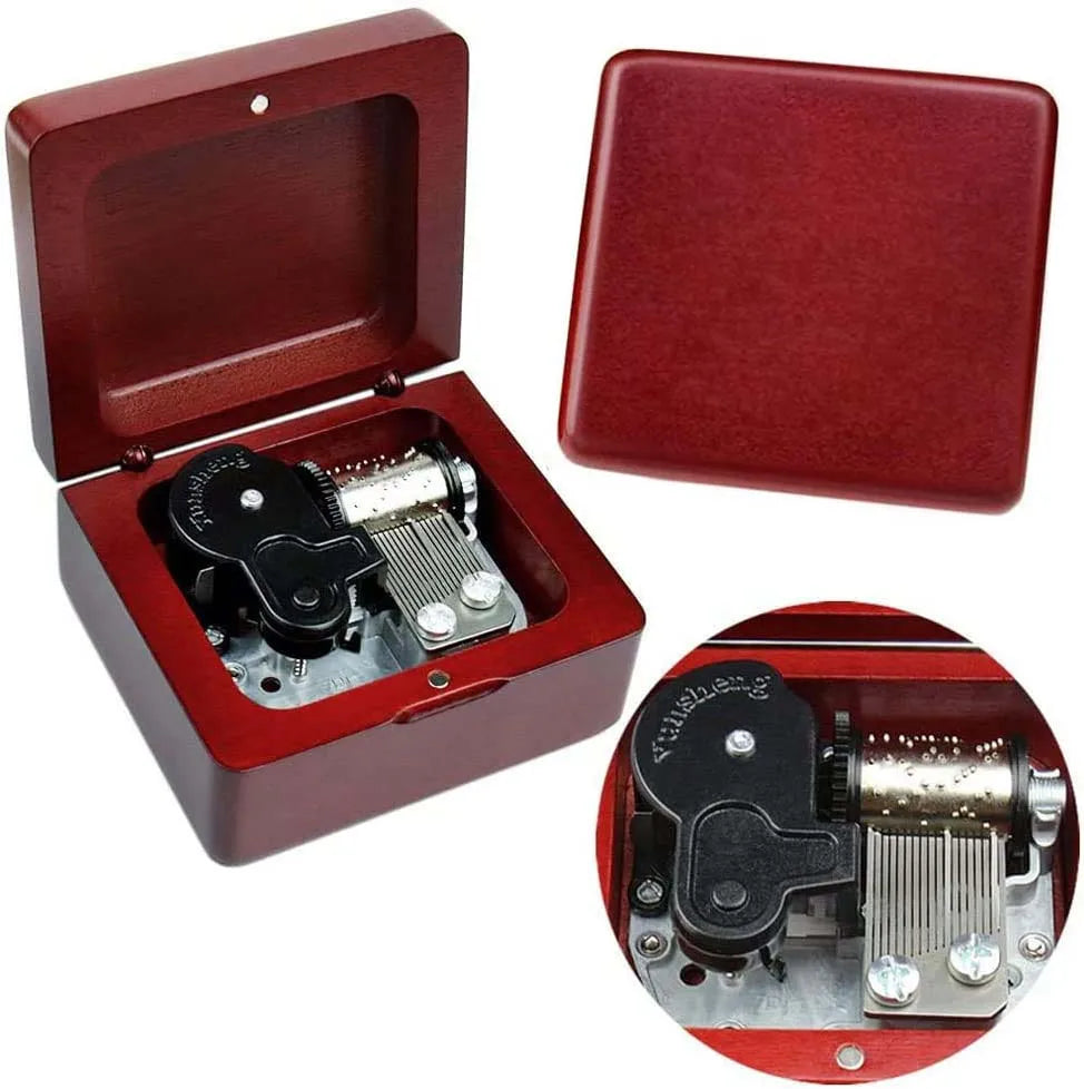 A red classic movie themed music box with an open lid showing the internal mechanism.