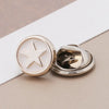Silver no-sew brooch buttons with a star design on a white background