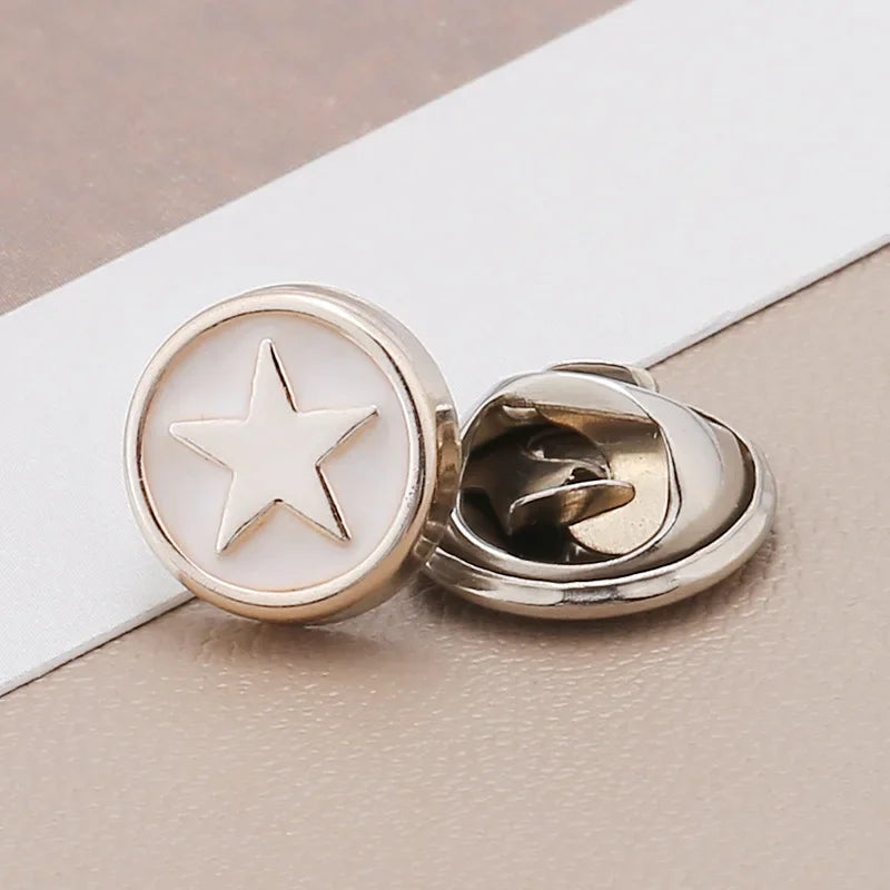 Silver no-sew brooch buttons with a star design on a white background