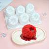 White silicone mousse molds with raspberry mousse in a baking tray