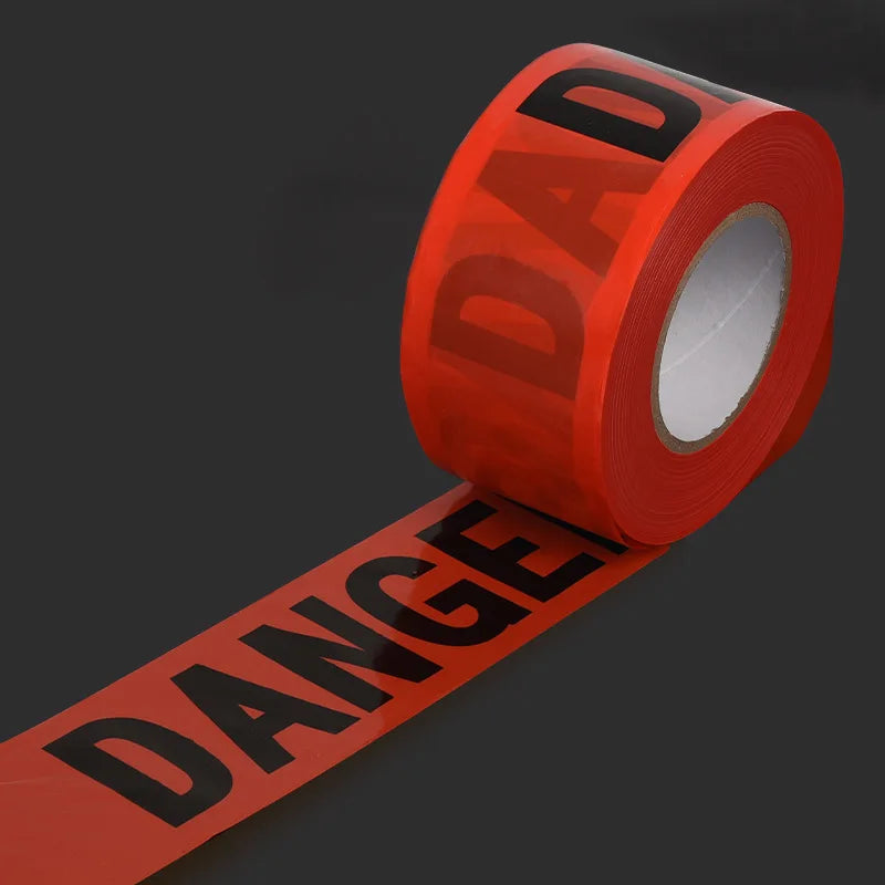 Roll of red caution tape with the word DAD visible on the label and a long strip of tape labeled DANGE