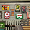 A collection of vintage metal tin signs featuring logos like BP, Mobil, and Gulf for garage wall decor.