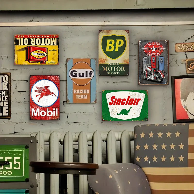 A collection of vintage metal tin signs featuring logos like BP, Mobil, and Gulf for garage wall decor.
