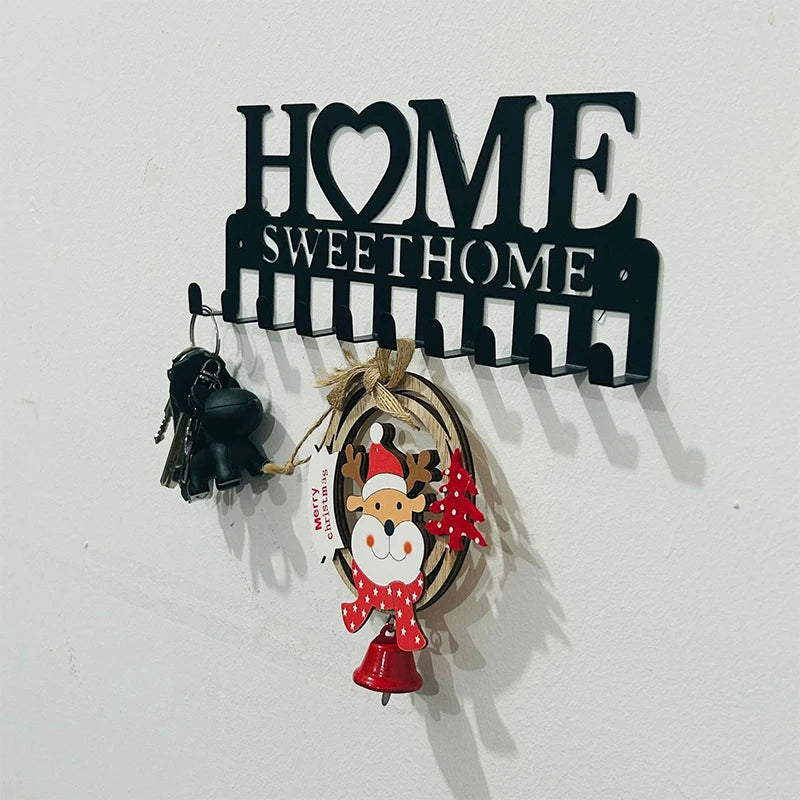 Black metal sign with the words HOME SWEET HOME and decorative hooks for a wall display