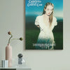 A vertical canvas print featuring a woman with long hair in a white dress against a green landscape and blue sky.