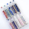 A set of ten clear glass roll-on bottles filled with various colored semi-precious stone roller balls.