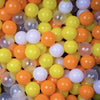 A close-up view of a 50-pack of colorful, translucent plastic balls in shades of orange, yellow, and white.