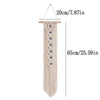 Beige macrame wall hanging with a fringe and an evil eye pendant