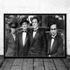 Black and white photo of three men dressed in suits posing for a movie poster