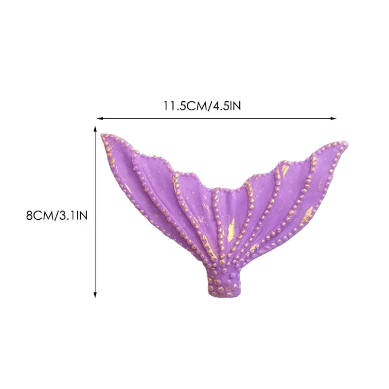 Purple mermaid tail cake topper featuring seashell and sea star decorations