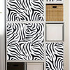 A display of zebra print self-adhesive peel and stick wallpaper samples in various sizes and textures.