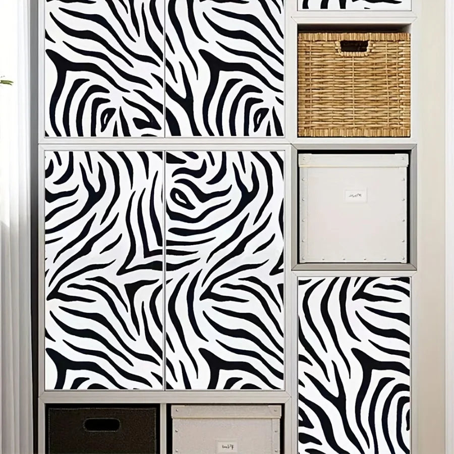 A display of zebra print self-adhesive peel and stick wallpaper samples in various sizes and textures.