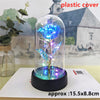 An LED galaxy rose artificial flower displayed inside a clear glass dome on a black base.