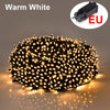 A close-up view of warm white LED string lights illuminating a dark background.