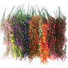A vibrant display of artificial morning glory hanging flowers in purple, blue, orange, and pink hues.