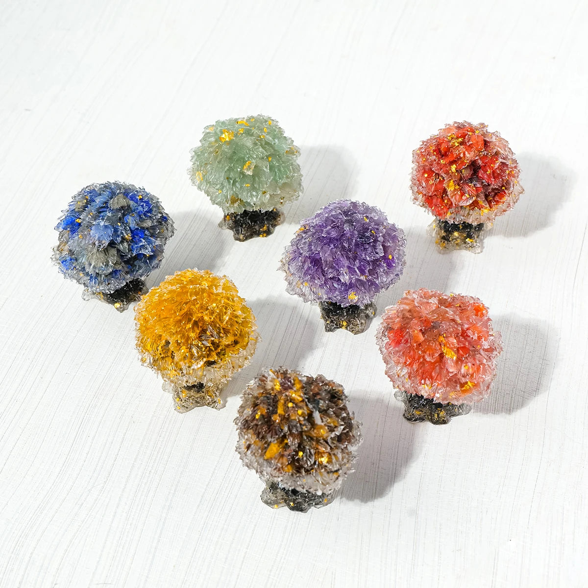 A collection of natural crystal mushroom tree sculptures in various colors including blue, green, purple, orange, and amber.