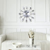 A modern cutlery 3D wall clock with silver forks and knives mounted on a white wall above a white sofa.