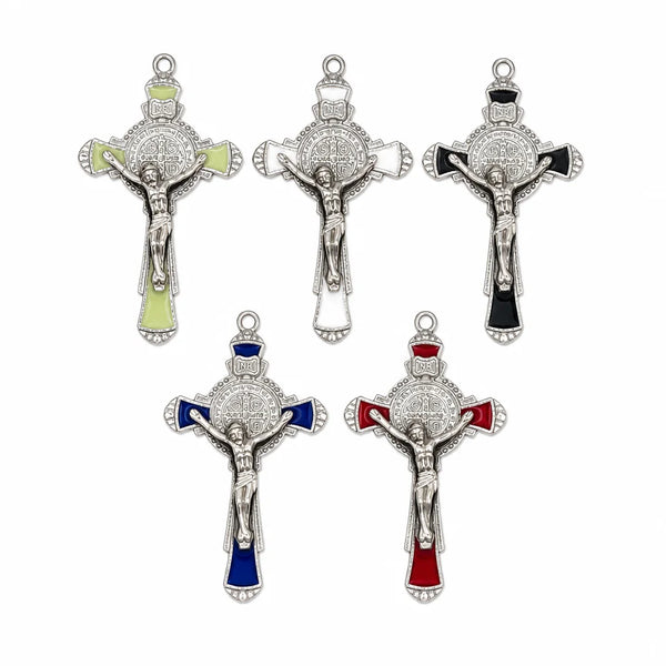 A set of five silver crucifix pendants with enamel finishes, including a large cross and smaller versions.