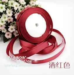 Roll of deep red silk satin ribbon for crafting or decoration