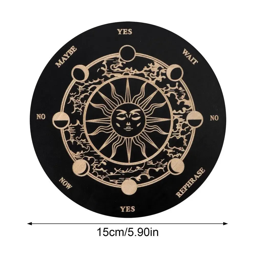 A round wooden divination board with a central sun design and directional words like YES, MAYBE, WAIT, NO, NOW, REPHRASE.
