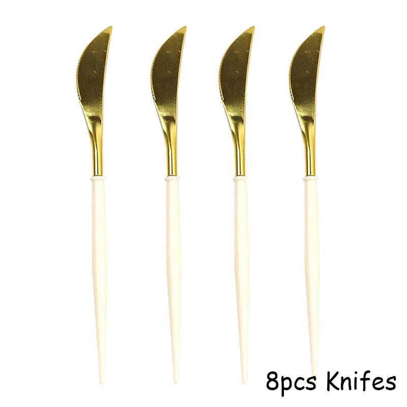Eight disposable gold knives with white handles