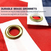 Close-up of a brass grommet on a white fabric, used for securing flags.