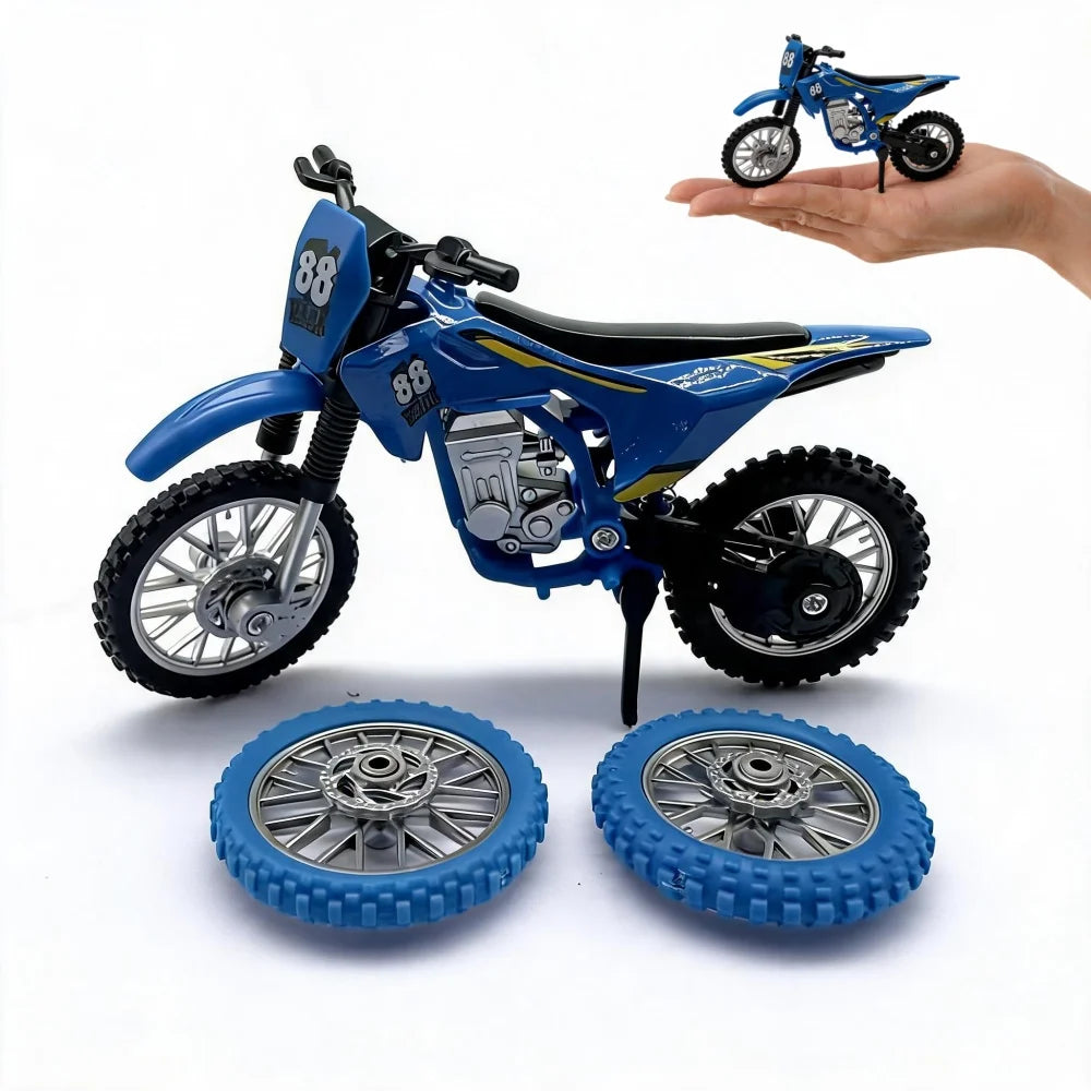 A blue 1:12 scale off-road motorcycle model with spare wheels is displayed next to a hand.