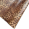 Close-up view of leopard print peel and stick wallpaper with brown and black spots.