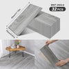 A pack of 32 wood grain peel-and-stick floor and wall stickers in gray, showing the size of a single piece.