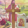 A wooden crucifix with a gold Jesus figure stands on a round base, set against a background of a painting.