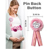 A woman shows off a pink floral maternity sash and corsage pin set for a baby shower